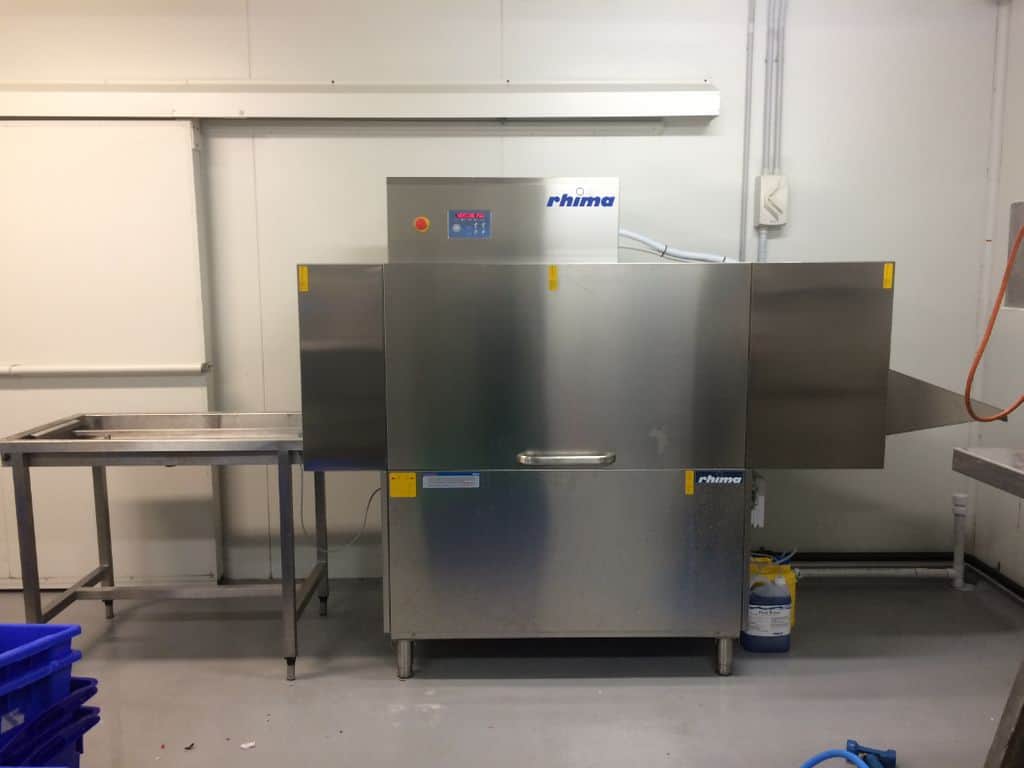 machine at seafood store washing crates and tubs