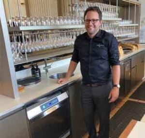 Craig in the bar at Chandon washing glasses with Rhima