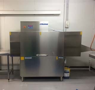 machine at seafood store washing crates and tubs